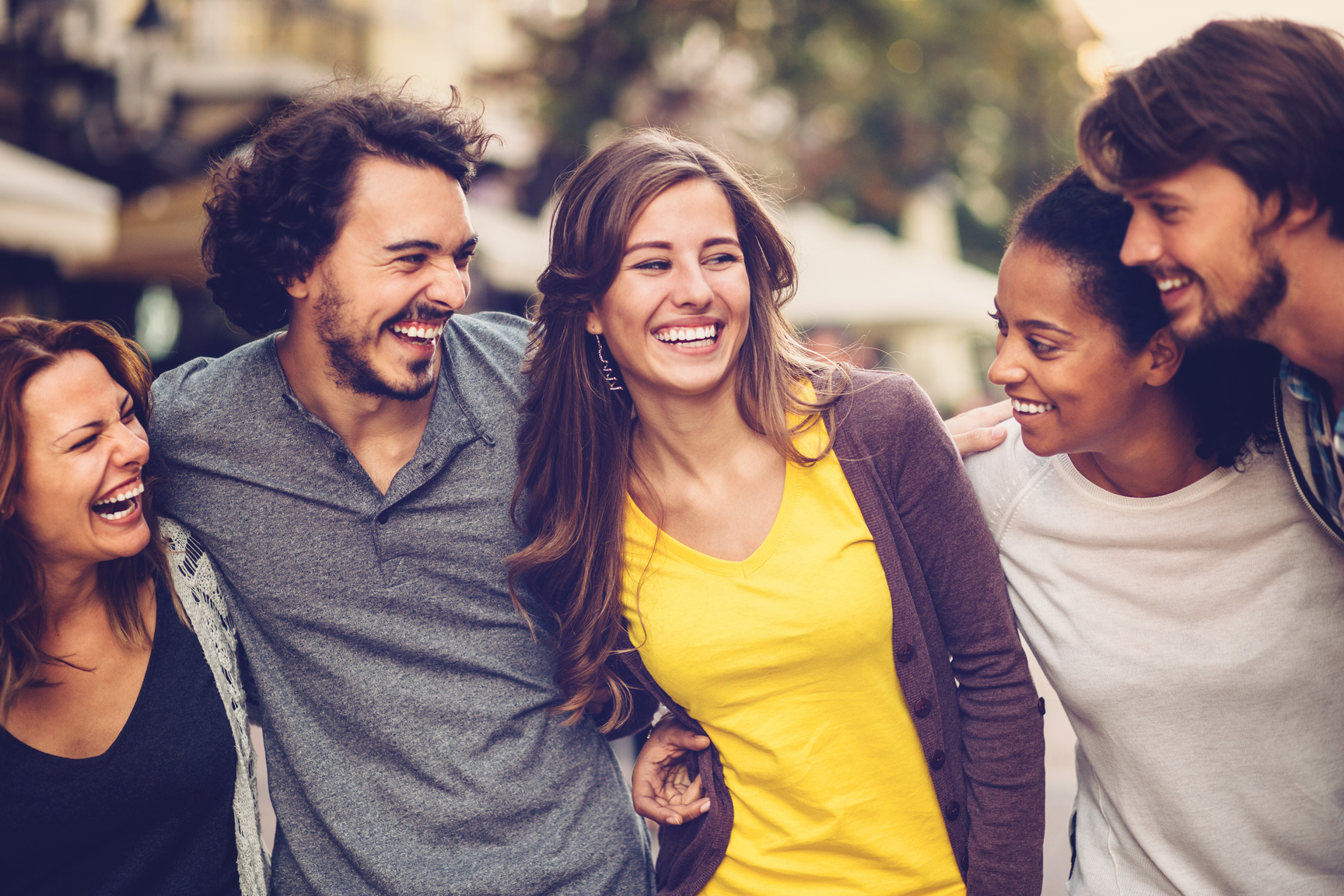 Group of mixed race young people smiling outdoors